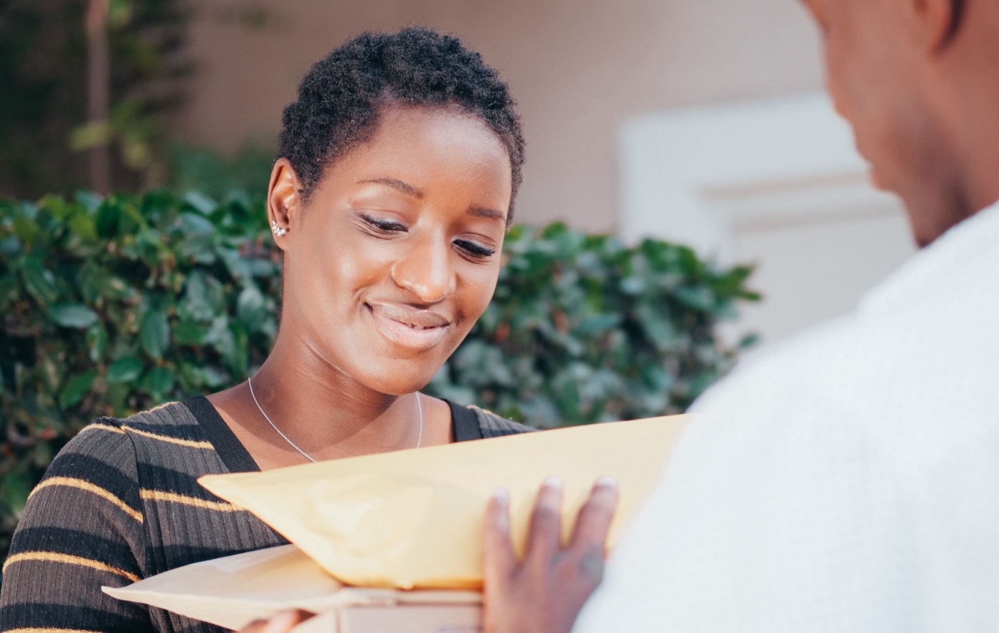 A smiling customer receiving her parcel